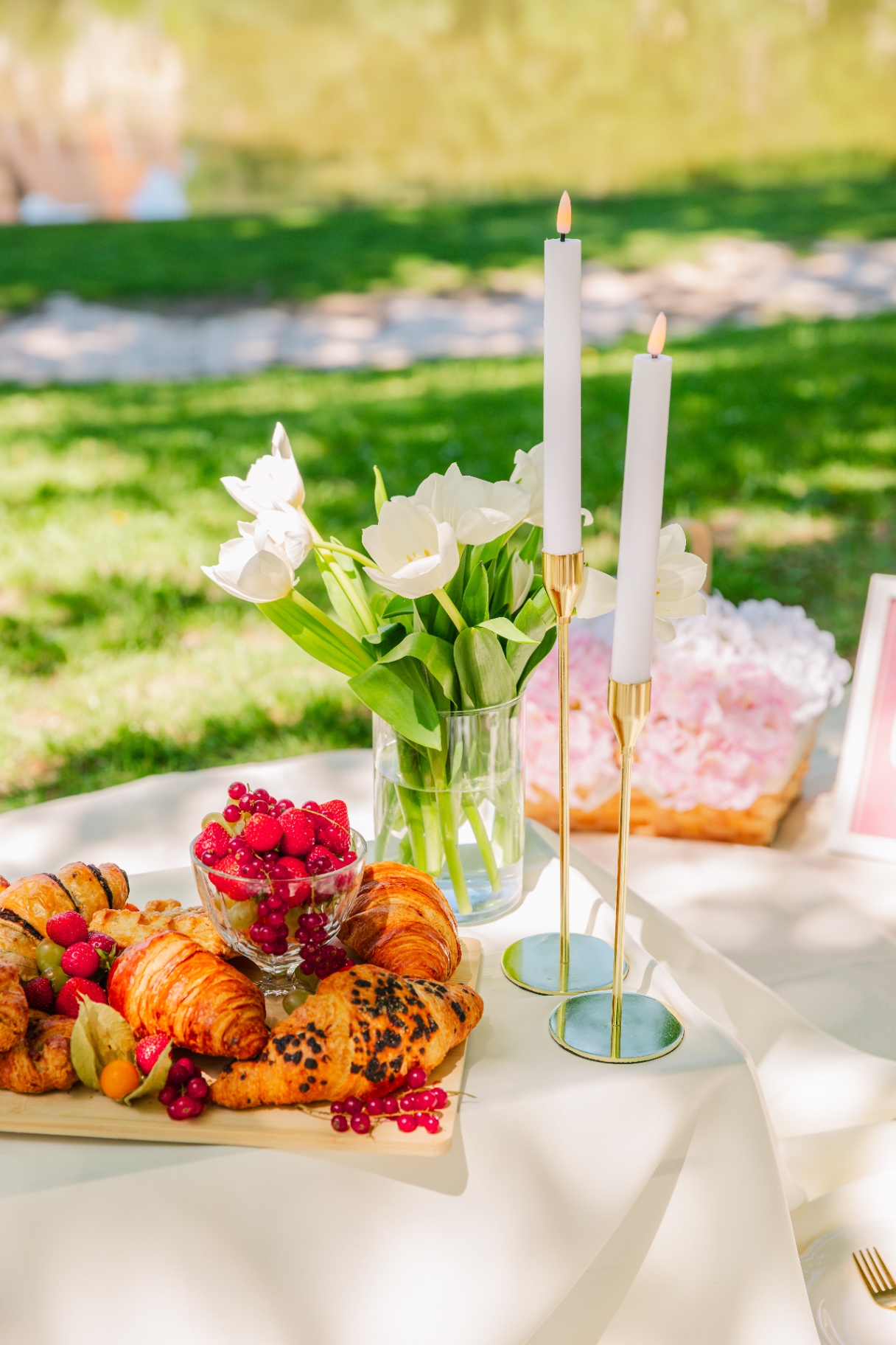 Golden croissant platter with white tulips, gold candlesticks and pink peonies